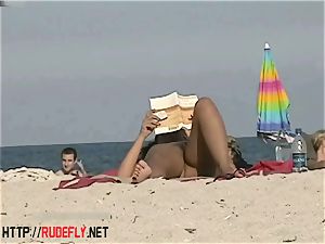 scorching honies filmed lying on a naturist beach